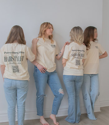 4 Brodava Employees posing with company shirts